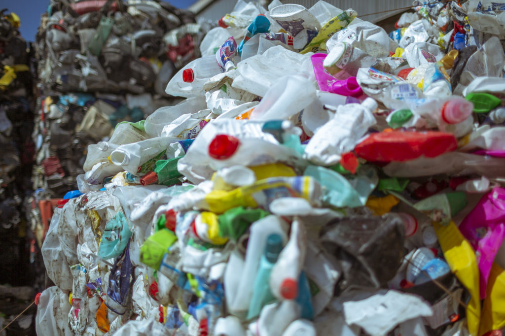Ilustračný obrázok stlačeného recyklovateľného plastového odpadu, najmä PET fľašiek.